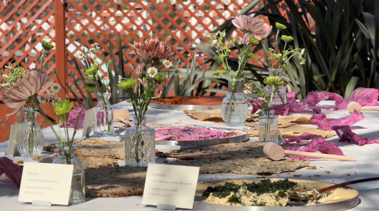 A garden table composed with flowers, edible textures, petals, and unexpected dishes for In Bloom