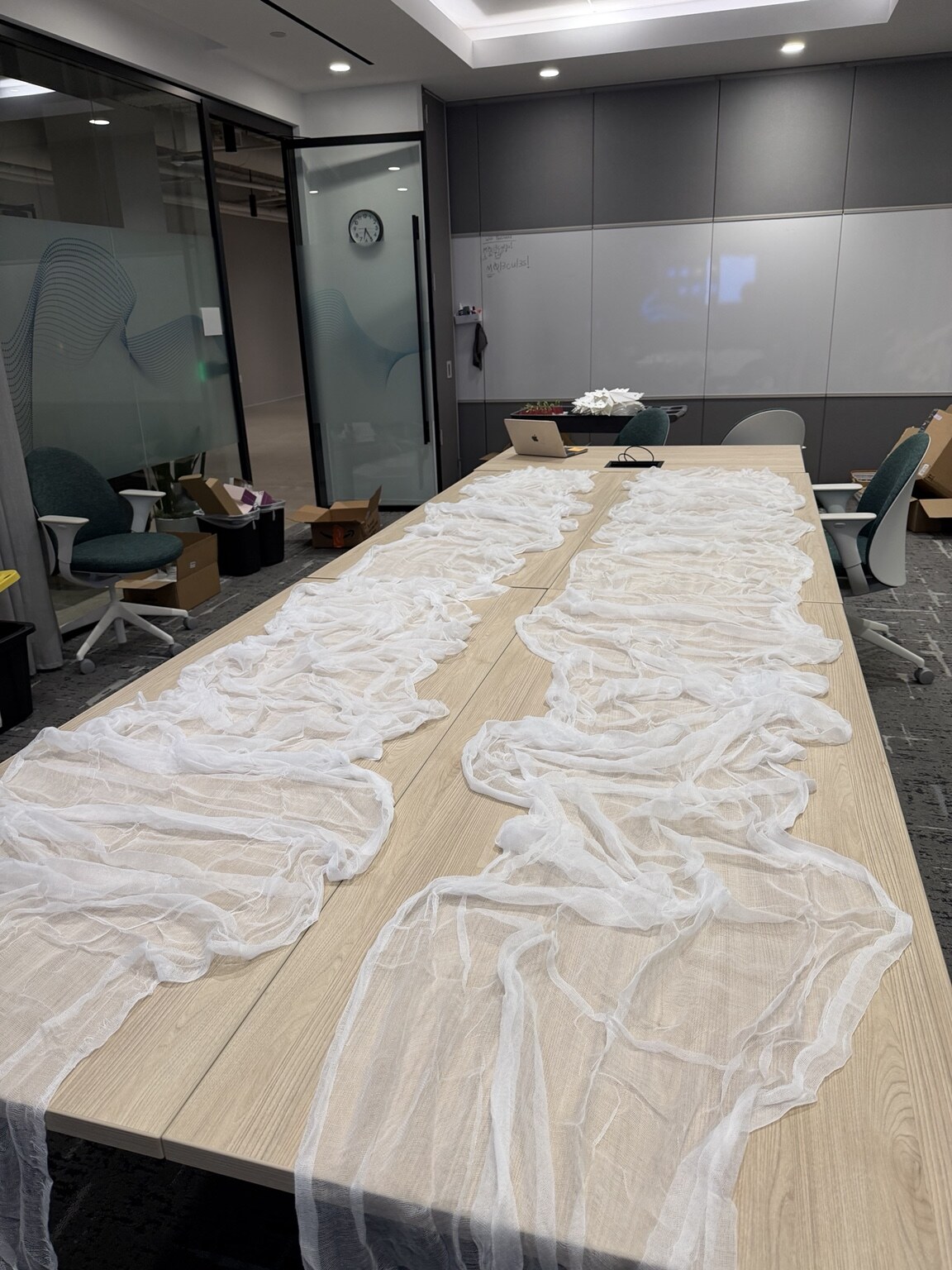 Fabric and materials being installed across the conference room tables