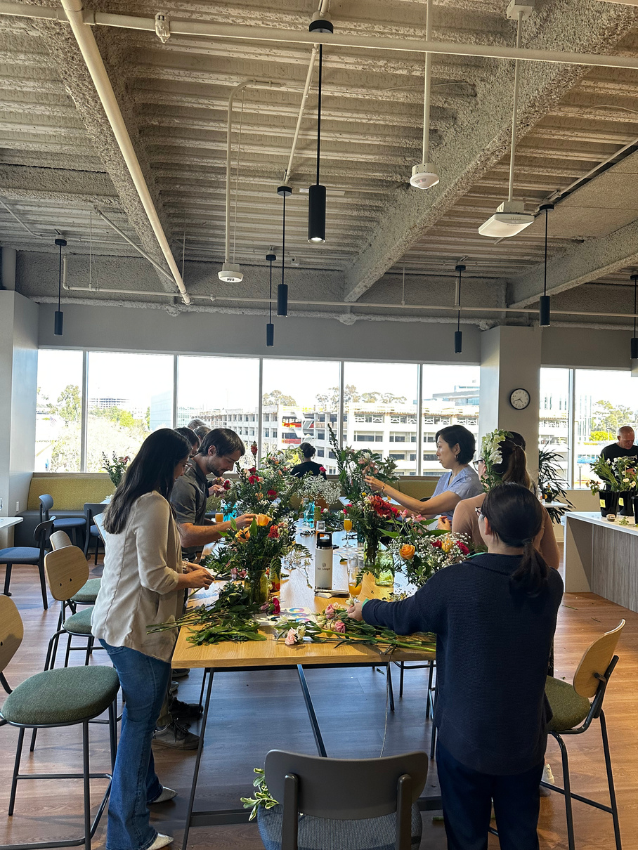 Colleagues arranging flowers together